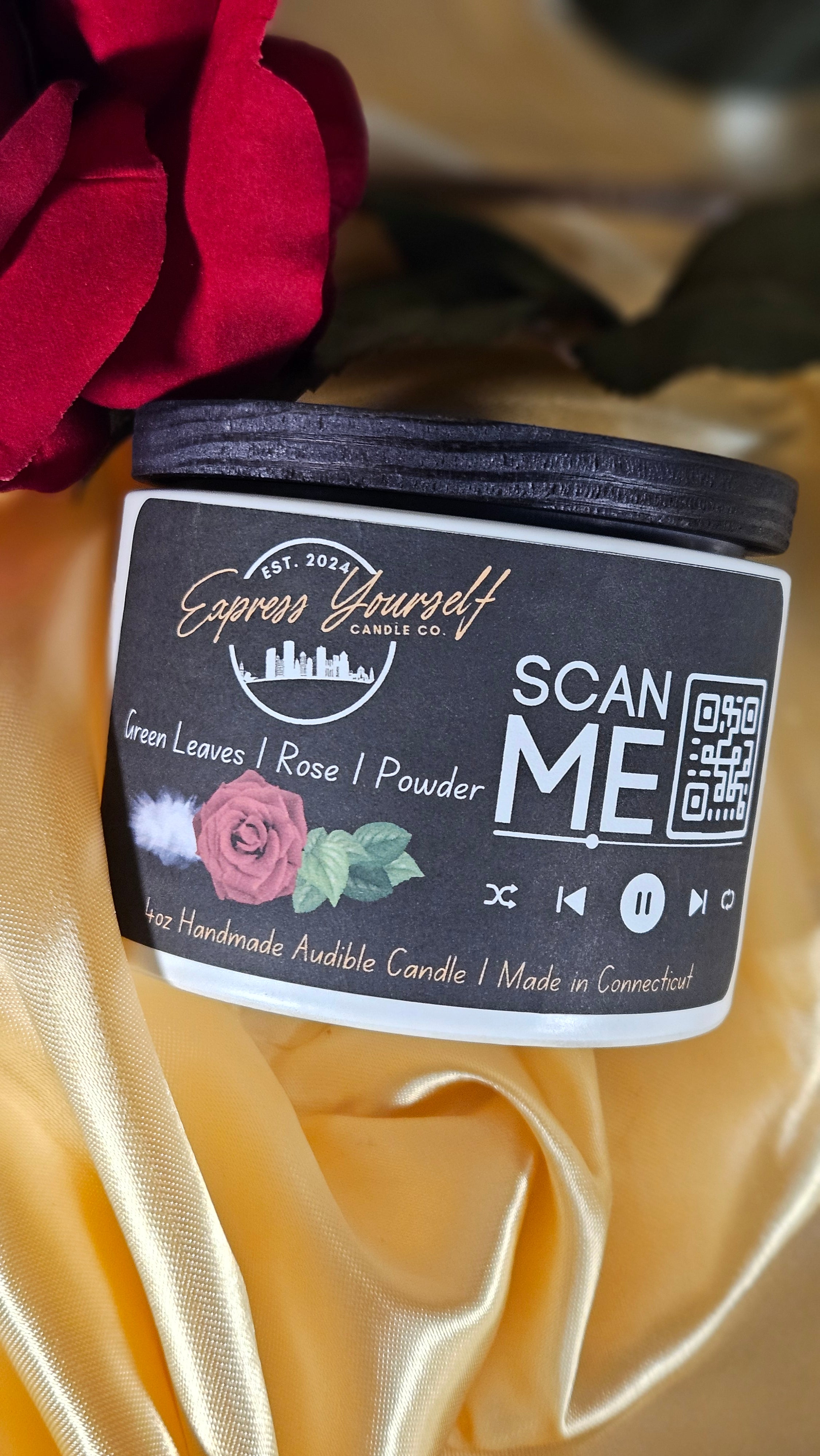 Mini Messenger personalized green leave and rose scented luxury candle with QR code audio experience on gold satin background.