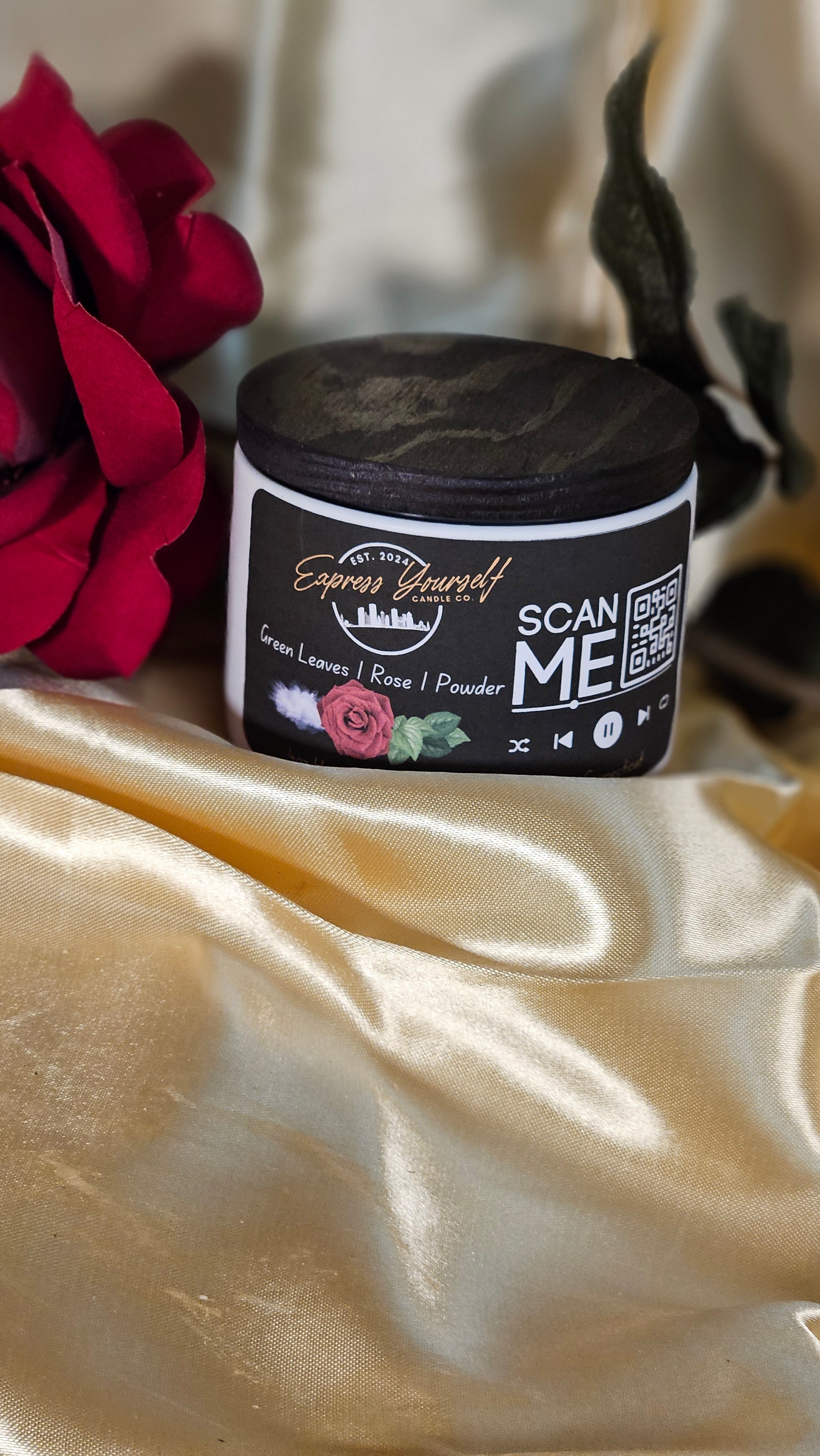Mini Messenger personalized green leave and rose scented luxury candle with QR code audio experience on gold satin background.
