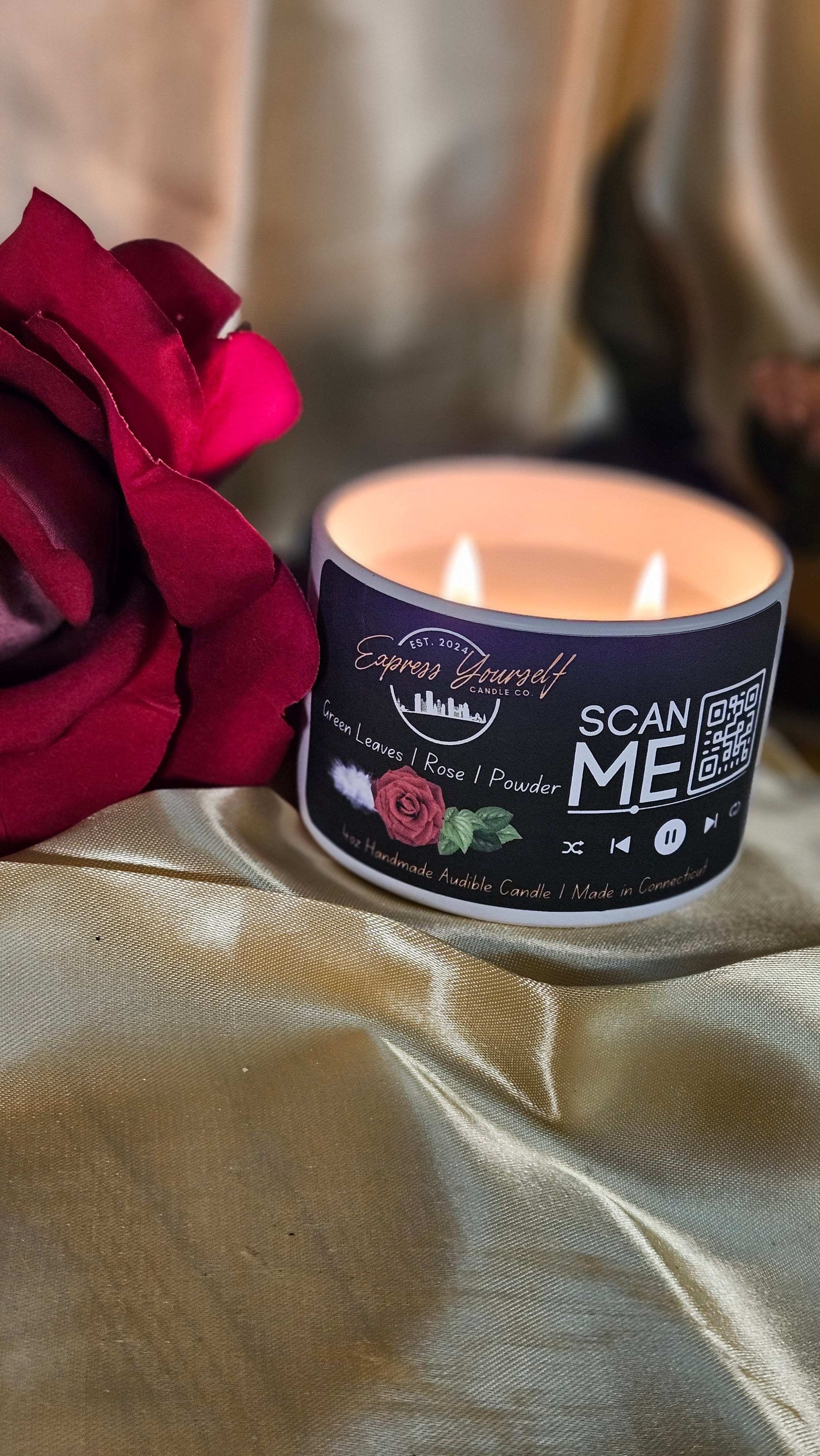 Mini Messenger personalized green leave and rose scented luxury candle with QR code audio experience on gold satin background.
