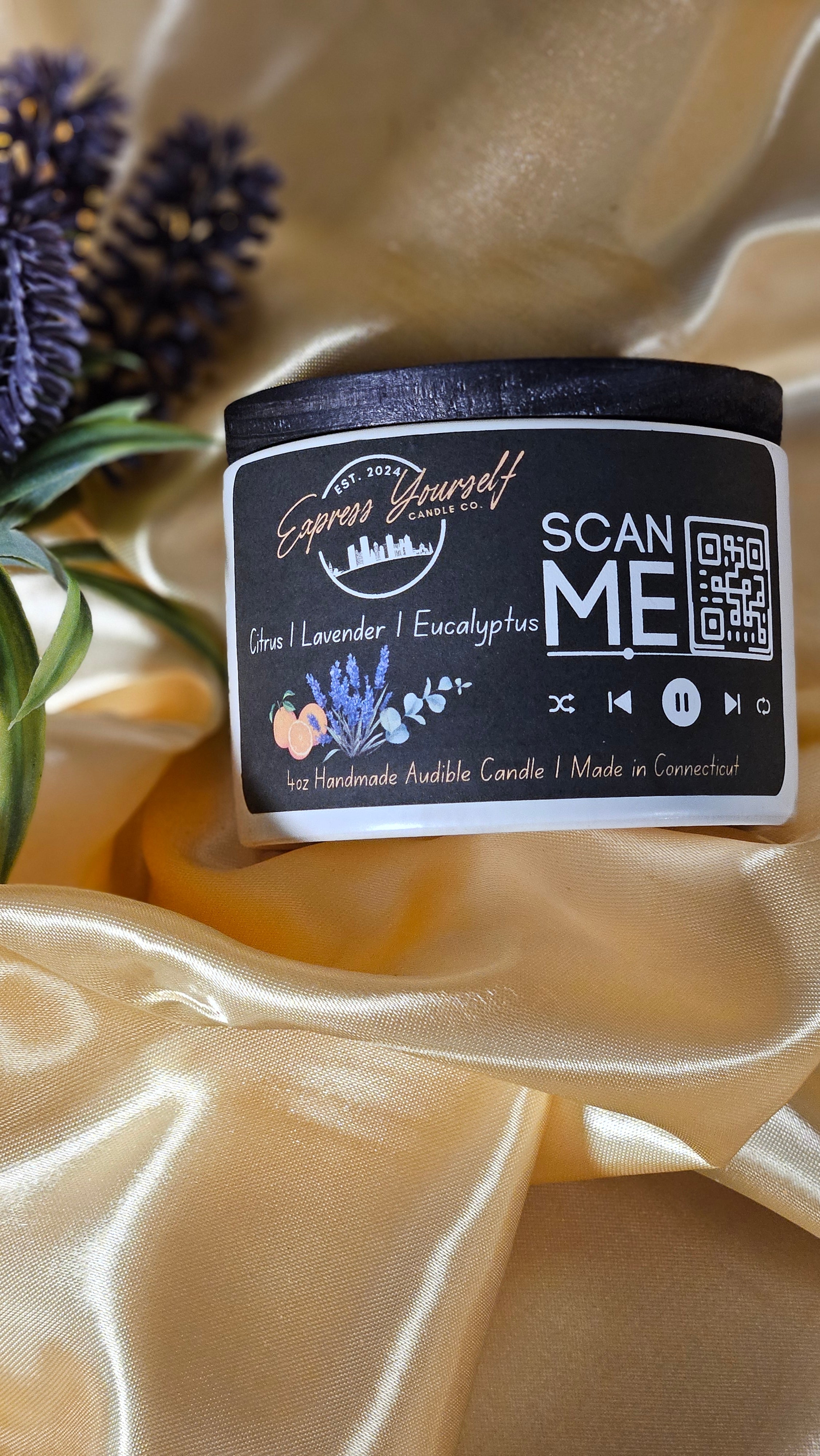 Mini Messenger personalized citrus, lavender, Eucalyptus, luxury candle with QR code audio experience on gold satin background.