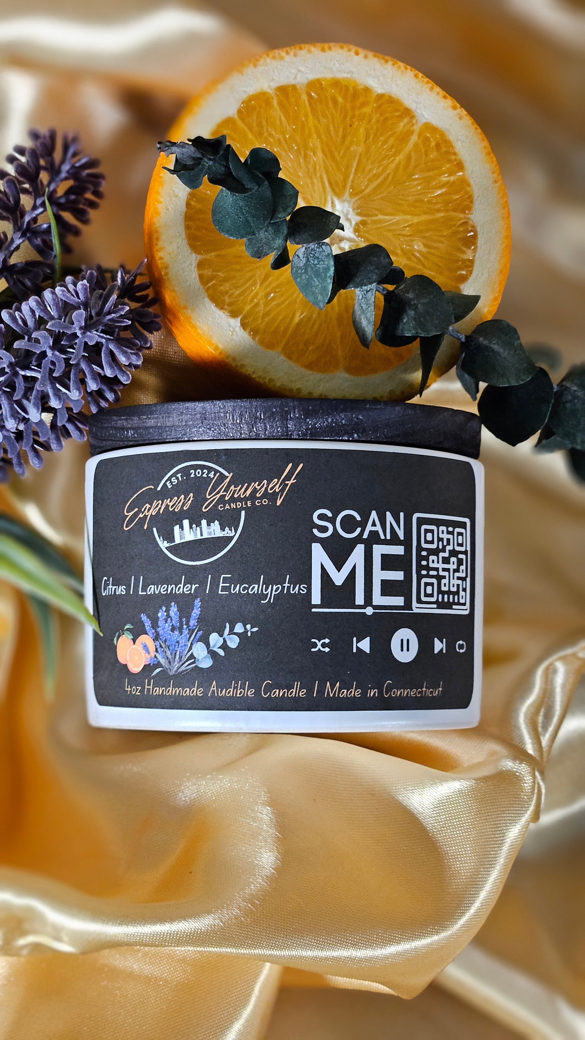 Mini Messenger personalized citrus, lavender, Eucalyptus, luxury candle with QR code audio experience on gold satin background.