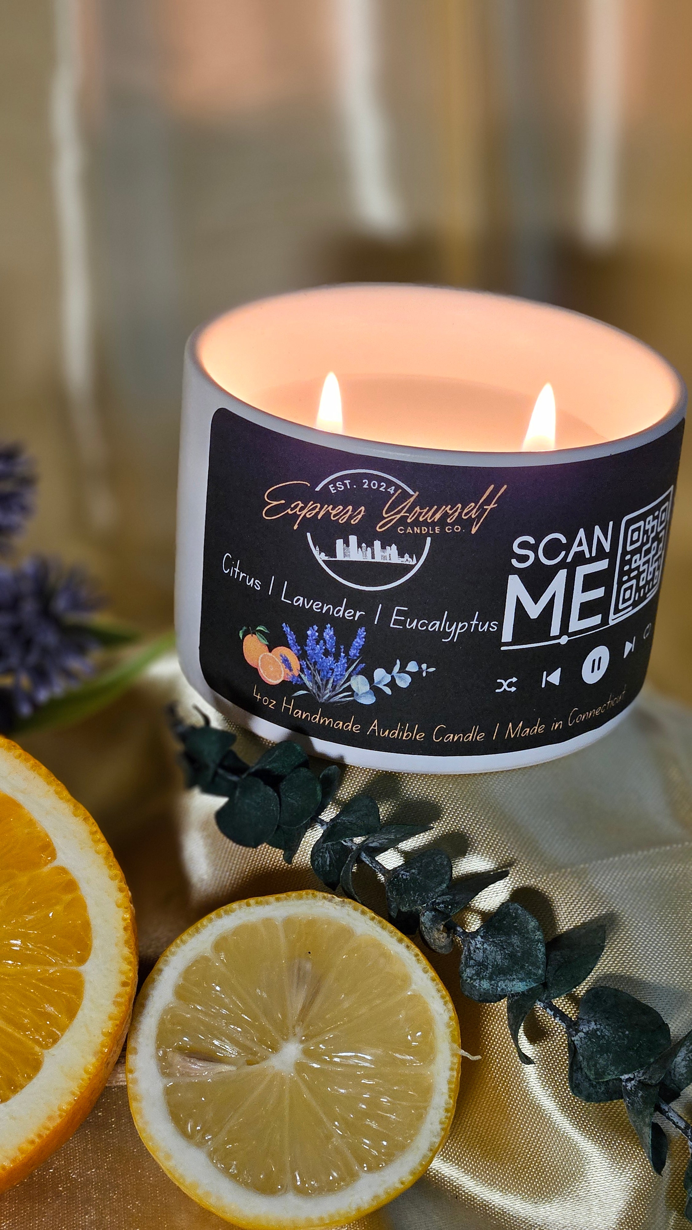 Mini Messenger personalized citrus, lavender, Eucalyptus, luxury candle with QR code audio experience on gold satin background.
