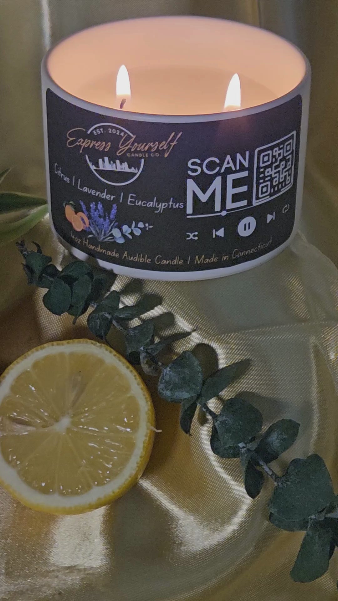 Mini Messenger personalized citrus, lavender, Eucalyptus, luxury candle with QR code audio experience on gold satin background.
